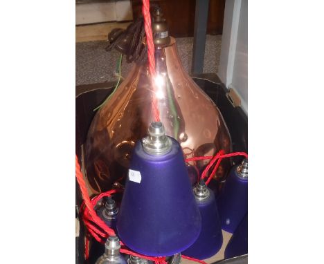 A collection of six modern blue hanging ceiling lamps with red electrical cord, a copper ceiling lamp together with three fur