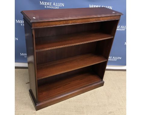 A modern mahogany open bookcase with adjustable shelving on a plinth base 100 cm wide x 30 cm deep x 104 cm high together wit