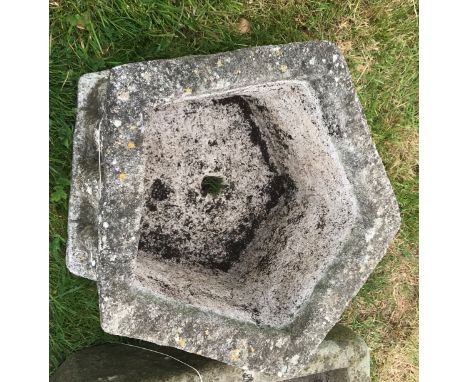 A weathered reconstituted stone pentagonal figural decorated planter, 46 cm diameter x 27 cm high, a rectangular plant trough