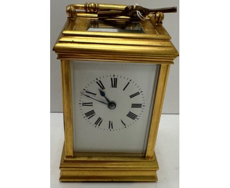 A 20th Century French gilt brass cased carriage clock, the movement of typical form, stamped to the back plate "France", in a