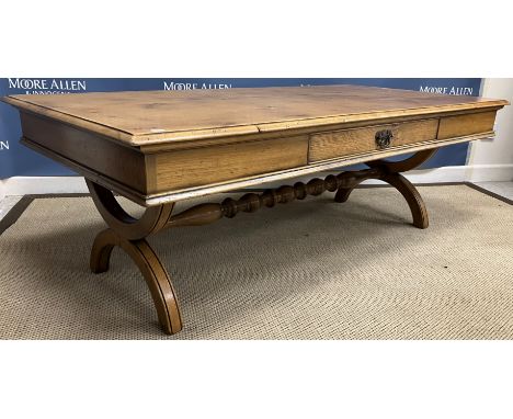 A modern oak dining table in the 17th Century Spanish style, the top with double fold-over leaves on lopers, with a single fr