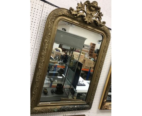 A circa 1900 giltwood and gesso framed wall mirror with scrolling foliate surmount, 65 cm wide x 101 cm high, a modern giltwo