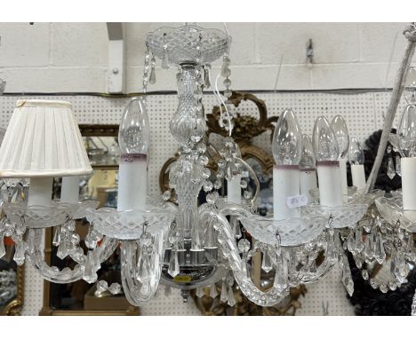 A 20th Century glass and brass six light electrolier in the Venetian taste with applied flower head medallion and glass drop 