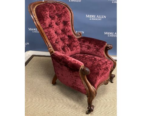 A Victorian mahogany framed button back salon armchair, the moulded scroll arms flanking a serpentine front seat with carved 