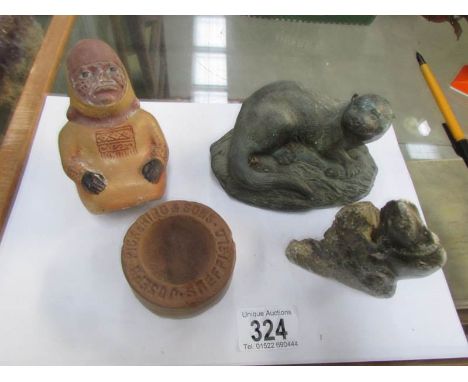 An old figure, an otter, a fish and one other item