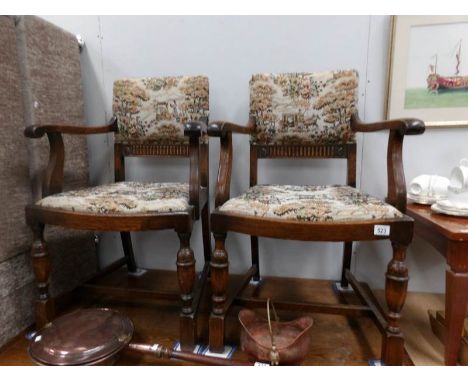A pair of oak elbow chairs with tapestry seats and backs