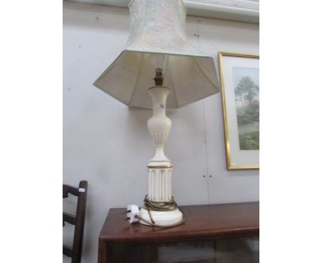 A ceramic table lamp with shade