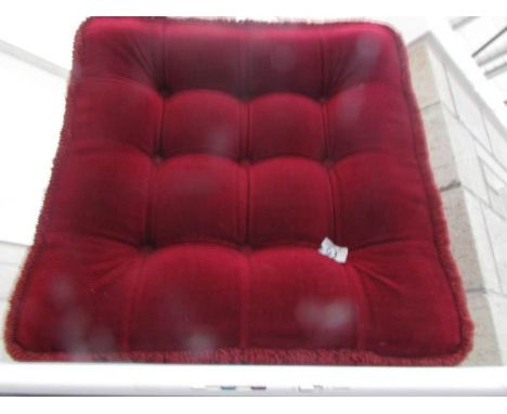 A burgundy dralon pouffe