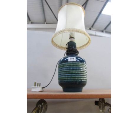 A ceramic table lamp with shade