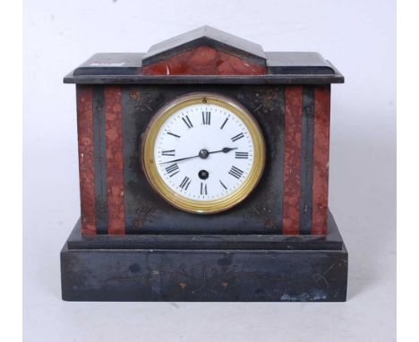 A late Victorian black slate and rouge marble mantel clock, of architectural form, having an enamelled dial with Roman numera