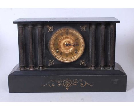 A late Victorian black slate mantel clock, of architectural form, having a gilt dial with Roman numerals and eight day moveme