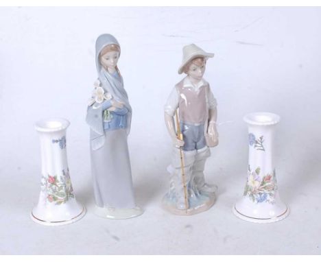 A Lladro Spanish porcelain figure of a boy with fishing rod and creel, having printed Lladro mark verso, height 22cm, togethe