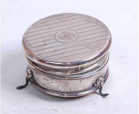 A George V silver trinket box, of circular form, having hinged lid with engine turned decoration, and silk lined interior