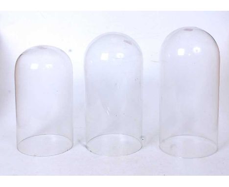 Three 20th century glass clock domes, height of largest 30.5cmCondition report: One of the larger domes has a lip to the base