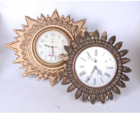 A mid 20th century electric Synclock, the circular enamel dial with Arabic numerals within a gold painted starburst surround,