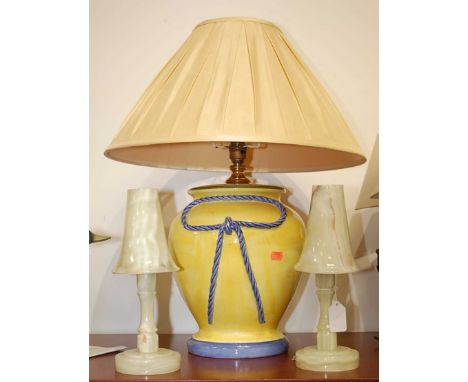 A pair of onyx table lamps, each having a trumpet shaped shade, h.27cm; together with a large yellow glazed pottery table lam