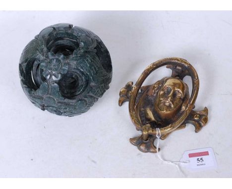 A carved and polished hard stone puzzle ball, together with a brass door knocker in the form of Shakespeare (2)