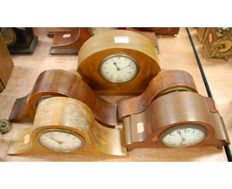 An Edwardian mahogany and boxwood strung mantel clock of shaped form having a circular dial with Roman numerals and eight day