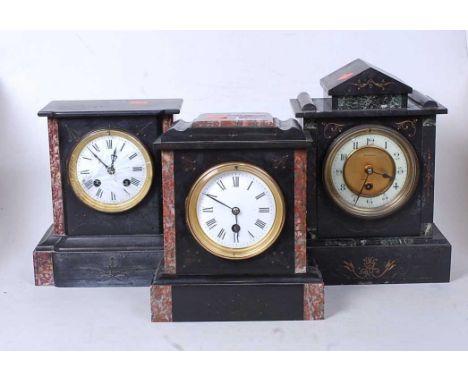 A late Victorian black slate and rouge marble mantel clock having a circular enamel dial with Roman numerals and 30 hour move