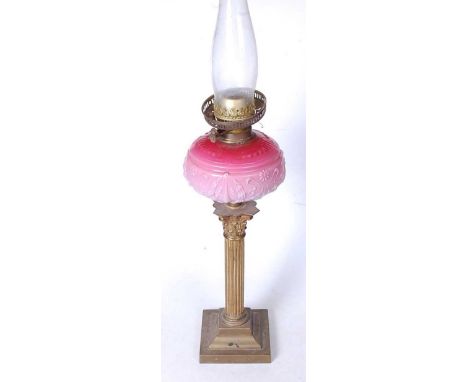 A Victorian oil lamp, having a pressed pink glass font, on a Corinthian column and stepped square base, h.50cm (excluding chi