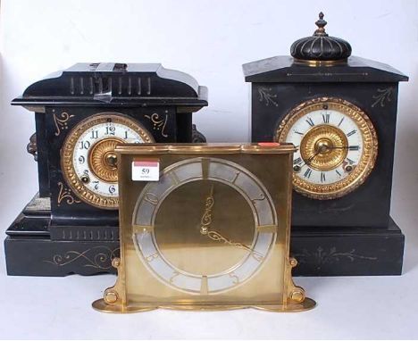 A late Victorian black slate mantel clock of architectural form having an enamelled chapter ring with Arabic numerals and eig