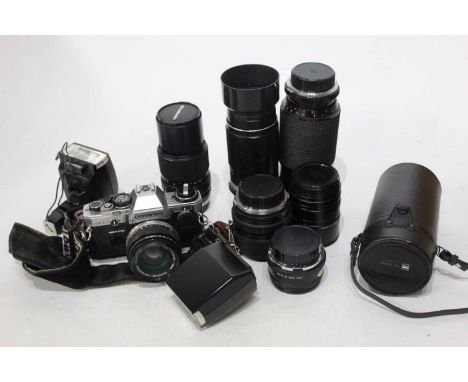 An Olympus OM10 camera in camera bag with various accessories to include flash etc. together with one other bag with various 
