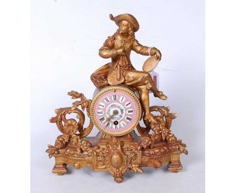 A late 19th century French gilt metal mantel clock, the central pink circular enamel dial with raised Roman markers, surmount