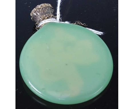 A green jade ovoid scent bottle having lightly etched decoration of a bird amidst flowering branches and embossed gilt metal 