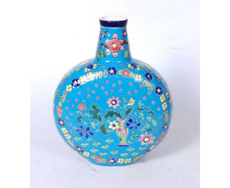 A modern Longwy style moonflask, of typical circular form, on a blue ground, the centre enamel decorated with a vase issuing 