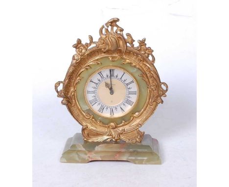 A Rococo style green onyx and gilt metal mounted mantel clock, the circular dial with Roman numerals within a scrolling surro