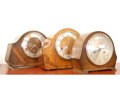 A 1950s walnut cased mantel clock, having enamelled chapter ring with Arabic numerals, chiming movement, h.23cm; together wit