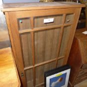 An oak display cabinet with single glazed panel door