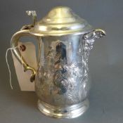 A pair of silver plated tankards with incised detail