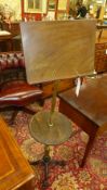 A Victorian brass and mahogany reading stand with arm on cast iron quadruped base