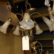 A wrought iron four branch chandelier with matching triple branch wall sconces