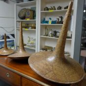 A set of three graduated Philippino spinning top style, leaf composition vases