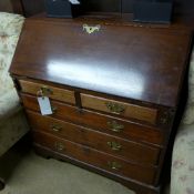 A George III mahogany bureau the fall front above two short and three long drawer on bracket feet