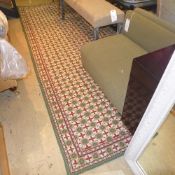 A large carpet the green ground with allover stylized geometric decoration