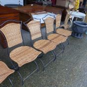 A set of six wrought iron and rattan conservatory chairs