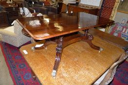 A George IV mahogany low table, the figured rectangular top on quadruple turned supports and sabre