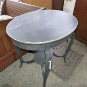 An Edwardian mahogany oval occasional table united by undertier