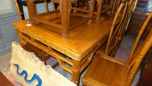A Chinese and bamboo style dining table with eight matching chairs