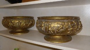 A pair of gilded plaster comports with cherub banding relief