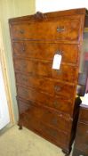 A mid C20th walnut tallboy with seven drawers on squat cabriole supports W 77 D 47 H 153 cm