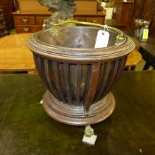 A C19th mahogany peat bucket with copper liner, slatted sides raised on gilt metal ball and claw