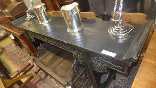 A Chinese black lacquered alter table the rectangular top above carved frieze on square section
