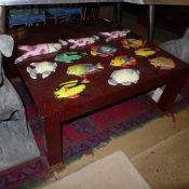 A C20th red lacquered square low table with brass feet