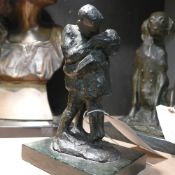 A bronze figural group ''Boy and girl kissing'' signed E Pozzi, mounted to green marble base. H 20