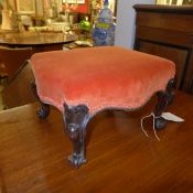 A Victorian walnut foot stool upholstered in orange fabric