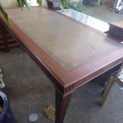 A mahogany library table the tooled leather top raised on tapered supports